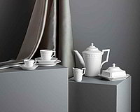 White porcelain on a gray pedestal.
