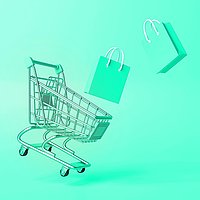 Shopping cart with bags against a green background.