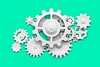 White cogwheels in 3D on a green background.