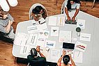 People sitting around a meeting table having a meeting