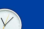 Wall clock on blue background.