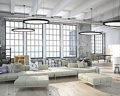 Loft with beige couch, large windows and ceiling lights