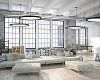 Loft with beige couch, large windows and ceiling lights
