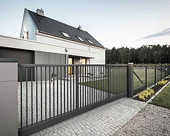 Gray sliding gate in front of family house