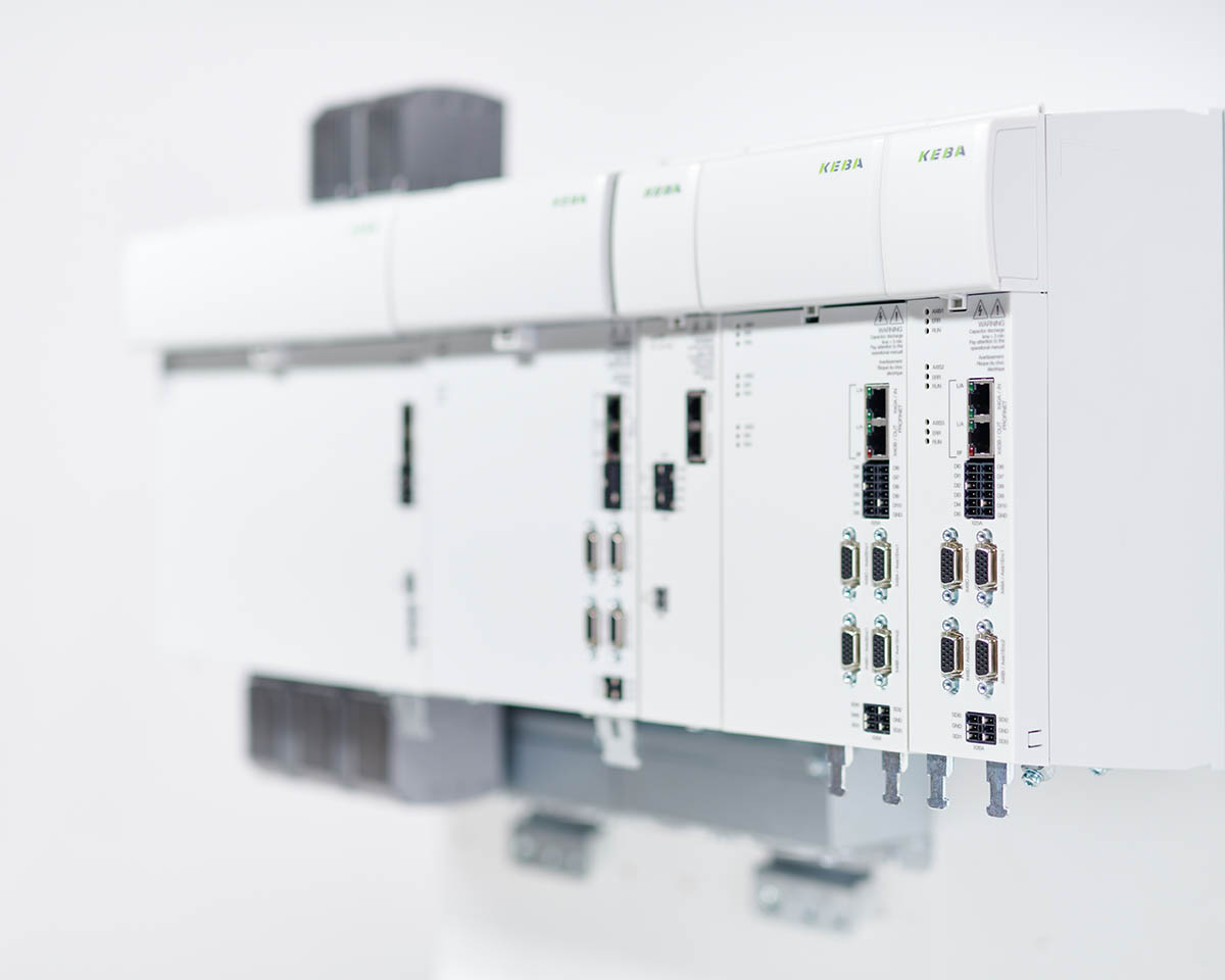Modular drive system from KEBA with several connected control modules in an industrial environment.